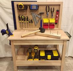 a workbench with tools and hammers on it