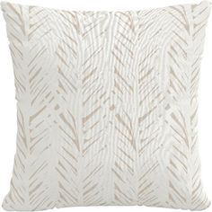 a white and beige pillow with an abstract design on the front, featuring diagonal lines