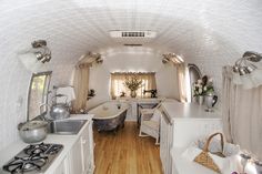 the interior of an airstrip with white walls and wood flooring is well lit