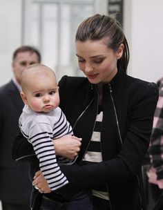 a woman holding a baby in her arms