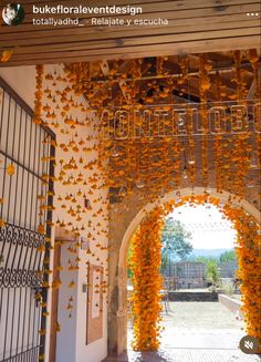 an archway decorated with orange flowers and butterflies