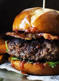 a hamburger sitting on top of a table next to french fries