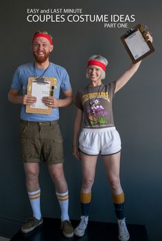 two people standing next to each other while holding up an award plaque and clipboard