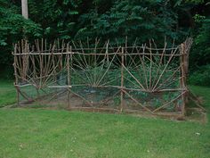 a garden fence made out of branches and sticks