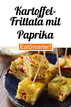 some food is on a blue plate with toothpicks in it and the words, kartoffe frittata mit paprka eatsmarti