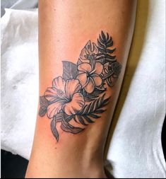 a black and white photo of a flower tattoo