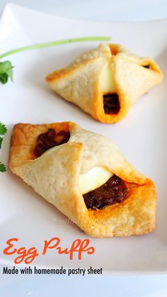 two pastries on a white plate with parsley