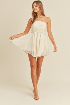 This stylish and versatile Strapless Babydoll Dress features a gathered, ruched, and pleated bust for a flattering fit. The back exposed zipper detail adds a touch of modernity, while the back smocking ensures comfort and flexibility. With a lining included, this dress is perfect for both casual and dressy occasions. Strapless Flowy Dress Short, Chic Strapless Mini Dress With Smocked Bodice, Strapless Flowy Mini Dress With Ruffles, Strapless Babydoll Dress, White Feminine Strapless Mini Dress, Exposed Zipper, Cream Roses, Zipper Detail, Cream Dress