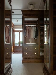 an empty walk in closet with clothes on hangers