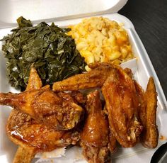 a white tray topped with wings and vegetables