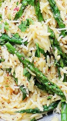 pasta with asparagus and parmesan cheese on top