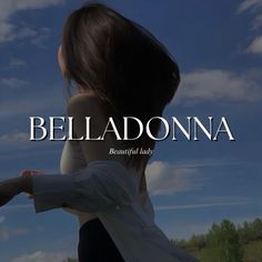 a woman standing in front of a blue sky with the words belladonna on it