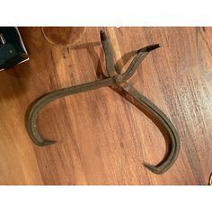 an old pair of scissors sitting on top of a wooden floor