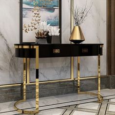 a black and gold console table with two vases on it in front of a marble wall