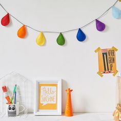 there is a white shelf with various items on it, including a framed photo and an orange vase