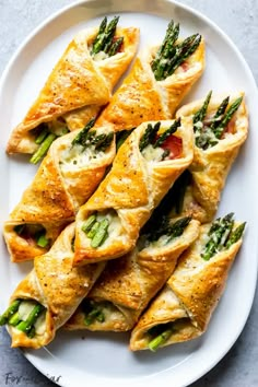 asparagus puff pastry bundles on a plate with text overlay that reads, asparagus puff pastry bundles