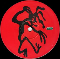 a red disc with black design on it