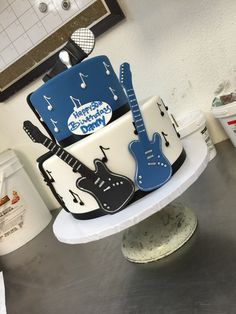 a birthday cake decorated with guitars and music notes