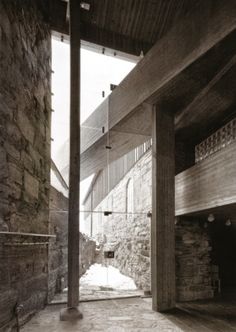 an old photo of the inside of a building that is made out of wood and stone