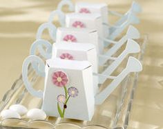 four small white bags with pink flowers on them