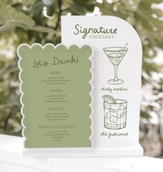 a menu card with an image of cocktails on it