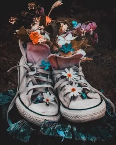 a pair of sneakers with flowers in them