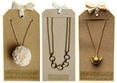 three different necklaces are shown in the same package as well as one with a bow