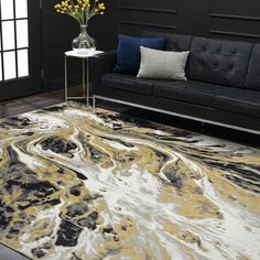 a living room area with black couches and white rugs