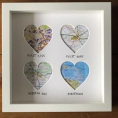 three heart shaped maps are displayed in a white shadow box with the words first kiss, first home, and third day