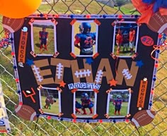 a sign that is on the side of a fence with balloons and streamers around it