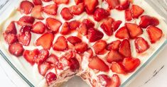 a cake with strawberries on top in a glass dish