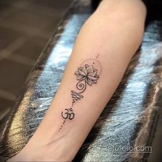 a woman's arm with a tattoo that has an om shant on it