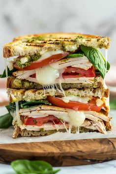 a cut in half sandwich sitting on top of a cutting board