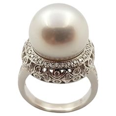 South Sea Pearl with Diamond 0.86 carat Ring set in 18 Karat White Gold Settings Width: 1.8 cm Length: 1.8 cm Ring Size: 54 Total Weight: 12.99 grams South Sea Pearl: 14 mm "We first opened doors in 1980 when it was then situated in the vicinity of the Victory Monument; a small and modest storefront with a couple of counters. From its humble beginnings to where it stands today, our company has proven its abilities as a jeweler. Since the beginning, we have been supplying fine quality pieces to d Pearl And Diamond Ring, Diamond Ring Settings, Sea Pearl, South Sea Pearls, Sea Pearls, Elegant Ring, Pearl Diamond, Pearl Ring, White Gold Rings