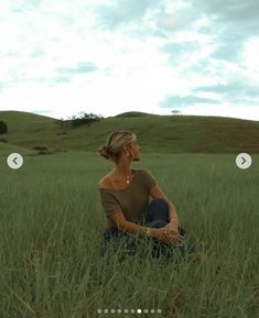 a woman sitting in the middle of a field