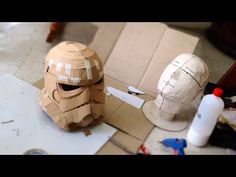 a paper mache helmet sitting on top of a table next to a cardboard box