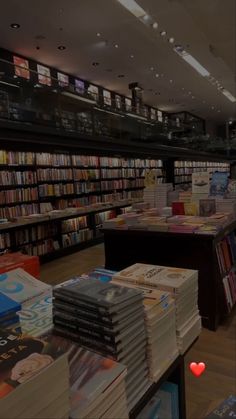 there are many books on the shelves in this bookstore, and one is red heart