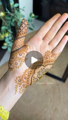 a woman's hand with henna on it