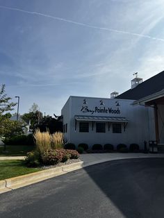 a white building sitting on the side of a road