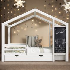 a child's bed with a chalkboard in the middle and stars on the wall