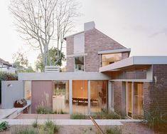 a modern house with an outdoor patio and dining area