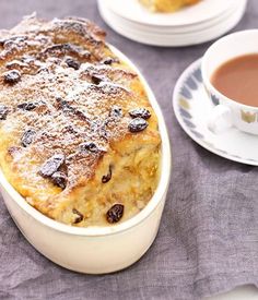 a casserole dish with raisins on top and a cup of coffee