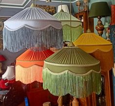 several different colored lamps hanging from the ceiling