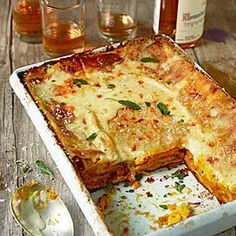 lasagna casserole with cheese and herbs on top