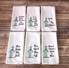 six hand towels with the words, merry christmas and a small church on each one