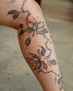 a woman's leg with flowers on it