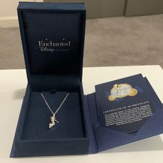 an open box with a necklace in it