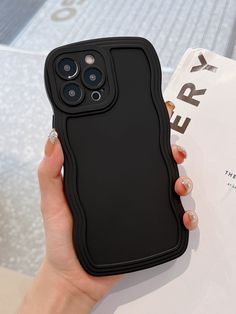 a woman is holding up her phone case