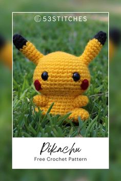 a crocheted pikachu sitting in the grass