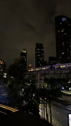 the city skyline is lit up at night